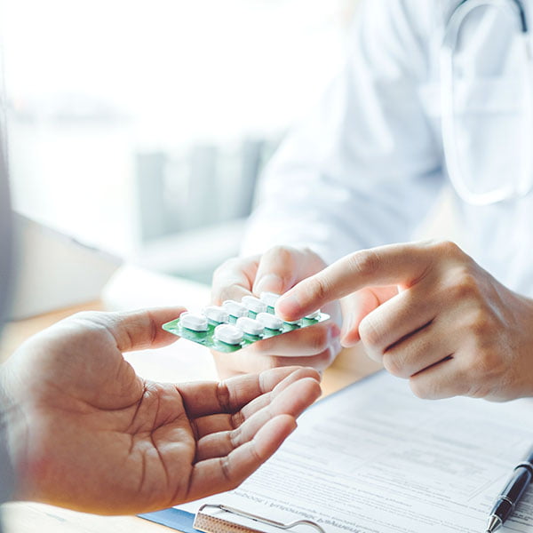 Doctor or physician recommend pills medical prescription to male Patient hospital and medicine concept