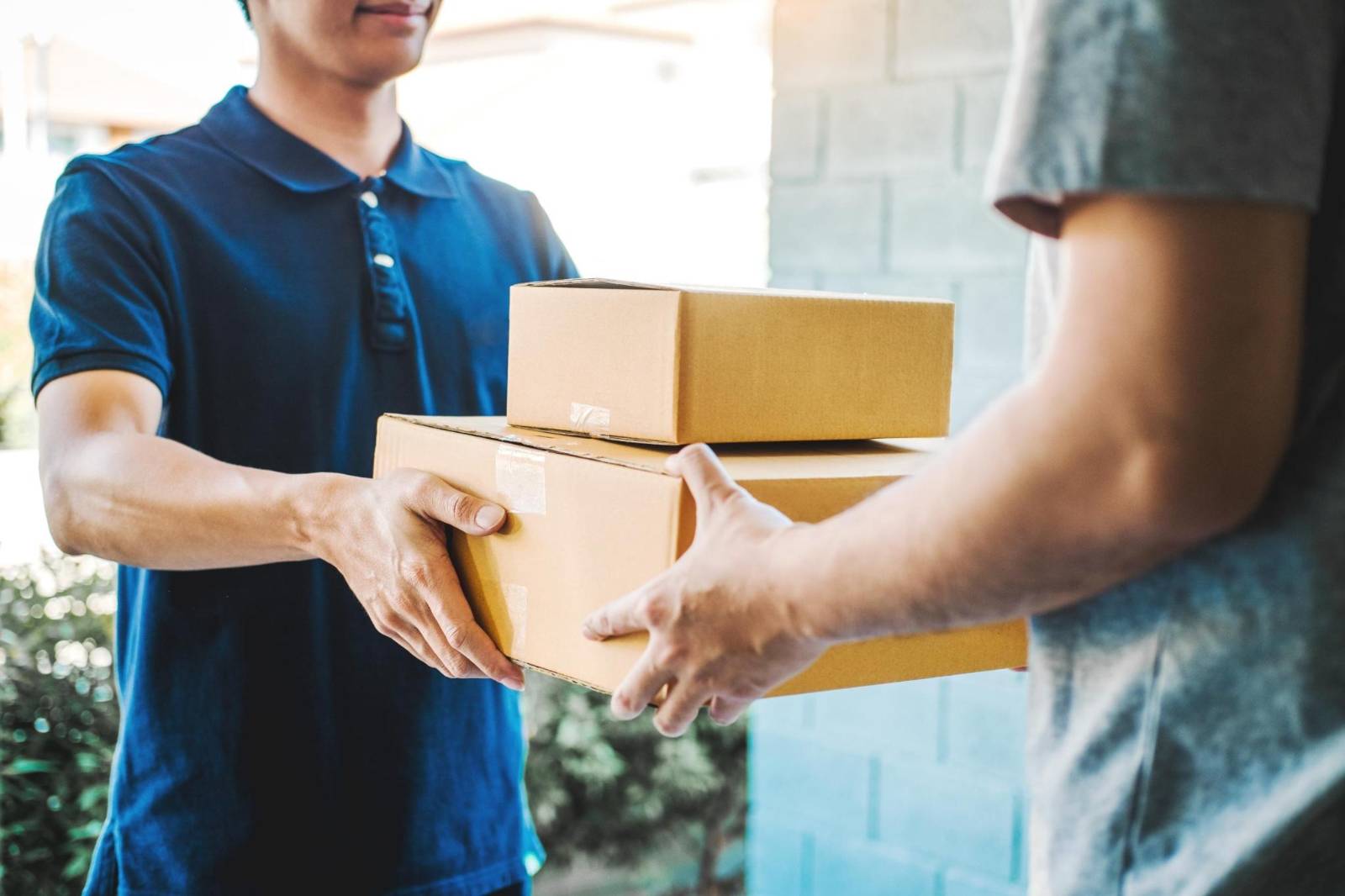 is it safe to buy eliquis from canada? - a person handing a box to another person